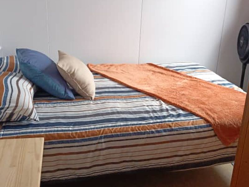 A functional bedroom space featuring neutral wall finishes and standard flooring.