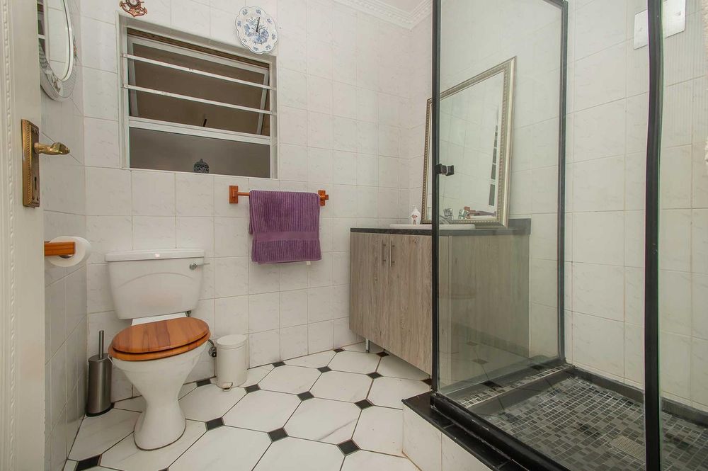 Modern family bathroom with shower, tiled to ceiling