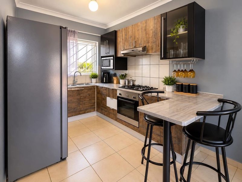 Modern kitchen featuring wood-look cabinetry, stone-effect countertops, integrated gas hob, oven, extractor fan, and a convenient breakfast bar area.