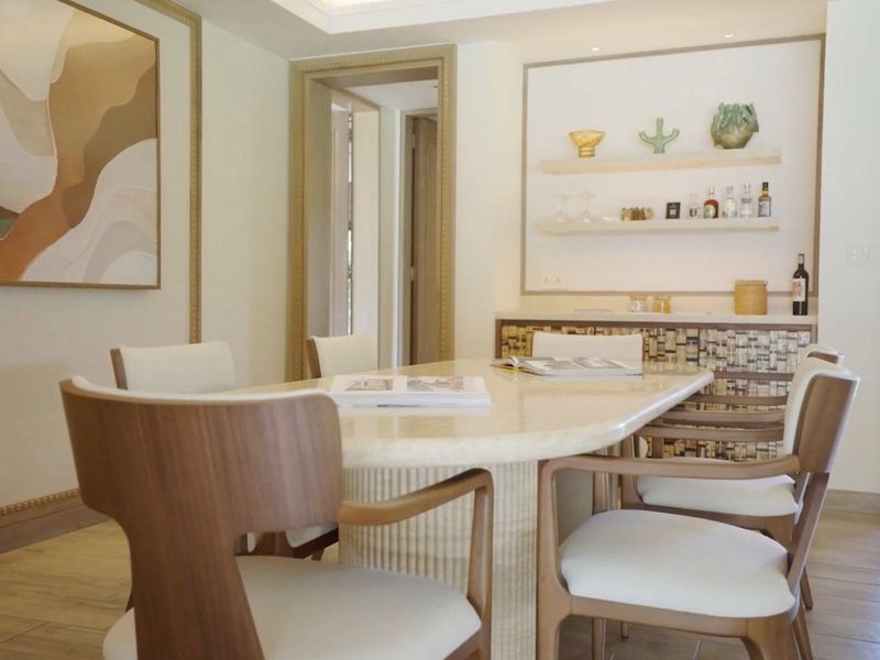 Elegant dining room featuring built-in shelving, recessed lighting, and high-quality finishes, creating a sophisticated space for formal meals and entertaining.