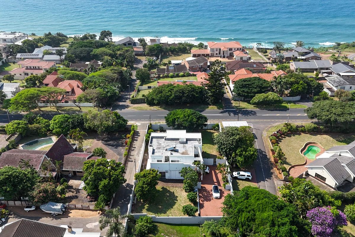 Aerial view of the property showing its location within the coastal neighborhood, proximity to the ocean, and surrounding residential landscape.
