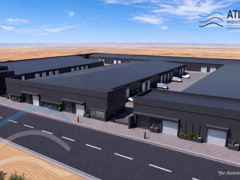 Aerial perspective of the Atlantic Industrial Park in Swakopmund, featuring modern warehouse units with roller shutter doors and paved access infrastructure.