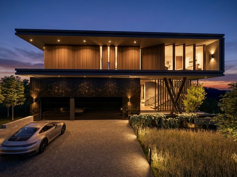 A modern architectural luxury home featuring a double garage, timber-clad upper level, and sophisticated exterior lighting at dusk.