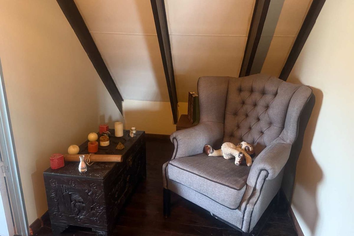 A cozy nook featuring exposed timber ceiling beams and dark wood flooring, creating a warm and characterful atmosphere within the home.