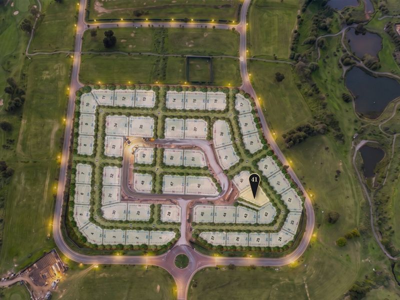 Aerial view of a residential estate development featuring marked plots, paved internal roads, and street lighting, with plot 41 highlighted.