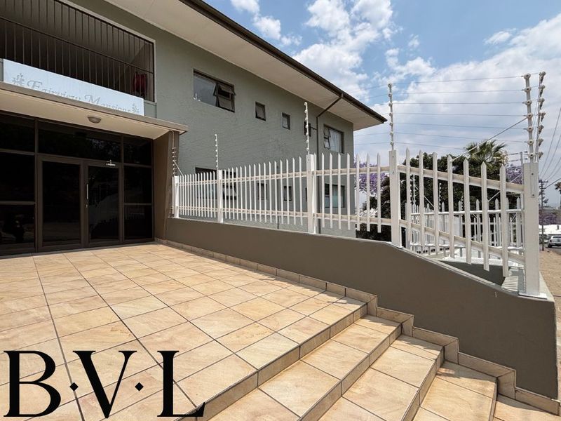 Front entrance area of Fairview Mansions featuring tiled steps, secure metal fencing, and electric security perimeter.