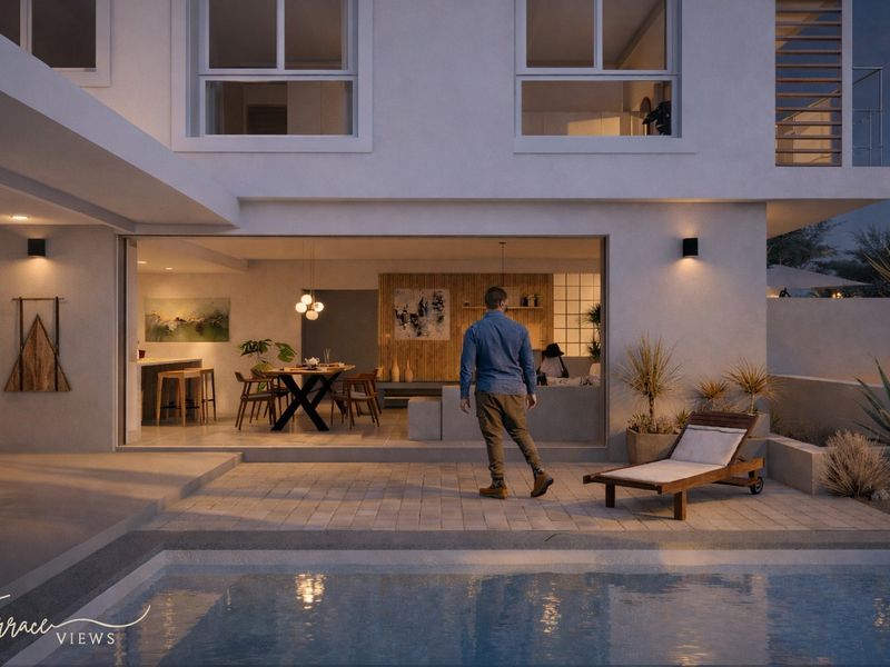A modern townhouse rear exterior featuring a paved patio, swimming pool, and seamless indoor-outdoor flow through large sliding glass doors.