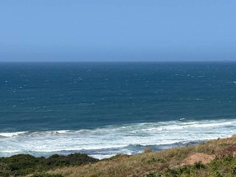 A scenic view of the ocean and coastline from the vacant residential property.