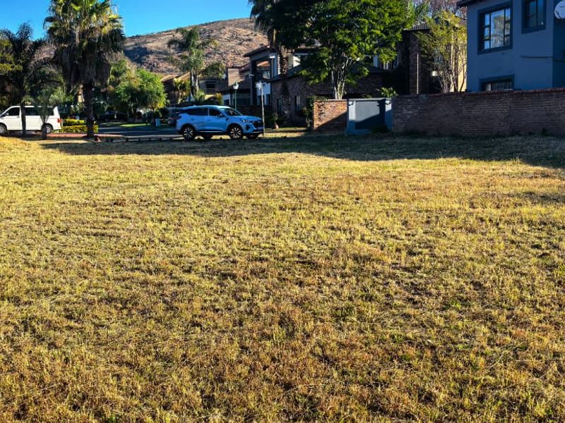 A vacant residential plot of land featuring established boundary walls and surrounding neighborhood views, ready for development.