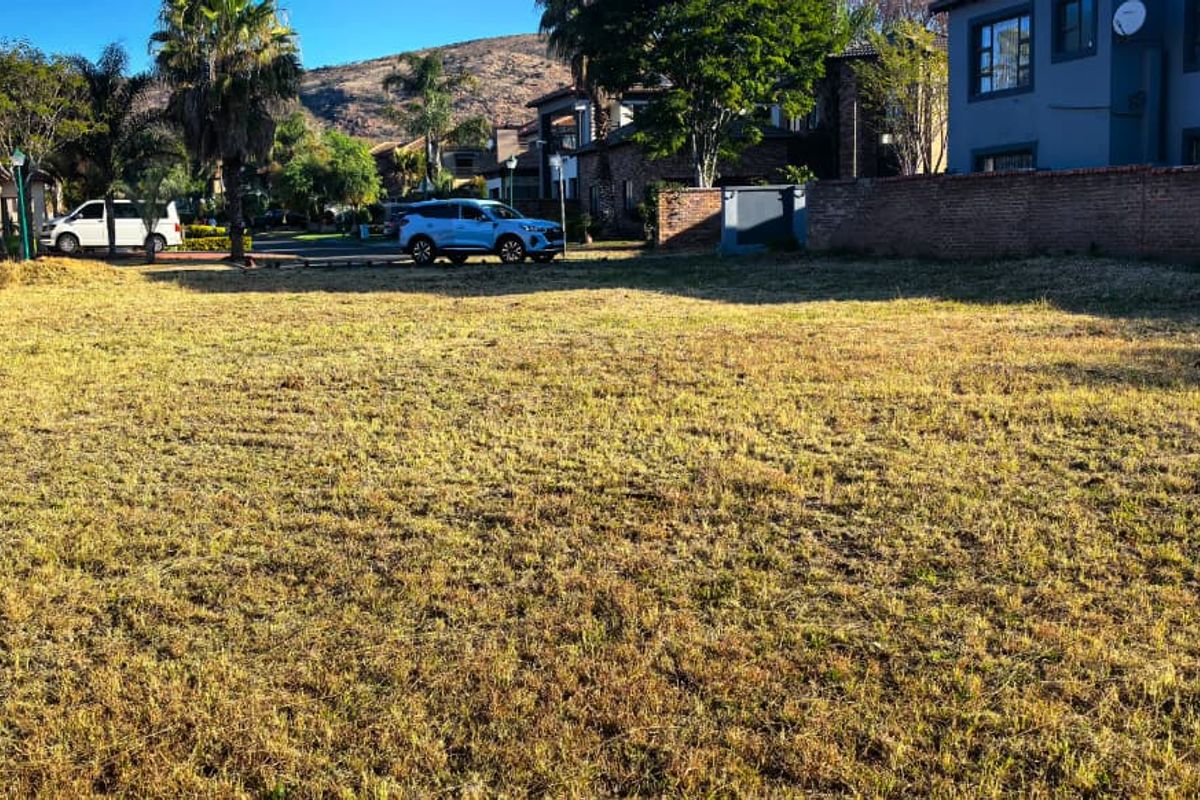 A vacant residential plot of land featuring established boundary walls and surrounding neighborhood views, ready for development.