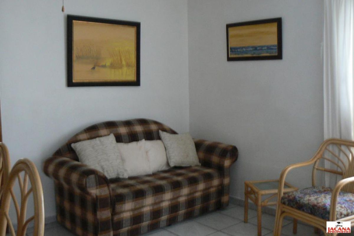 A living room area featuring tiled flooring and neutral wall finishes, providing a functional space for relaxation.
