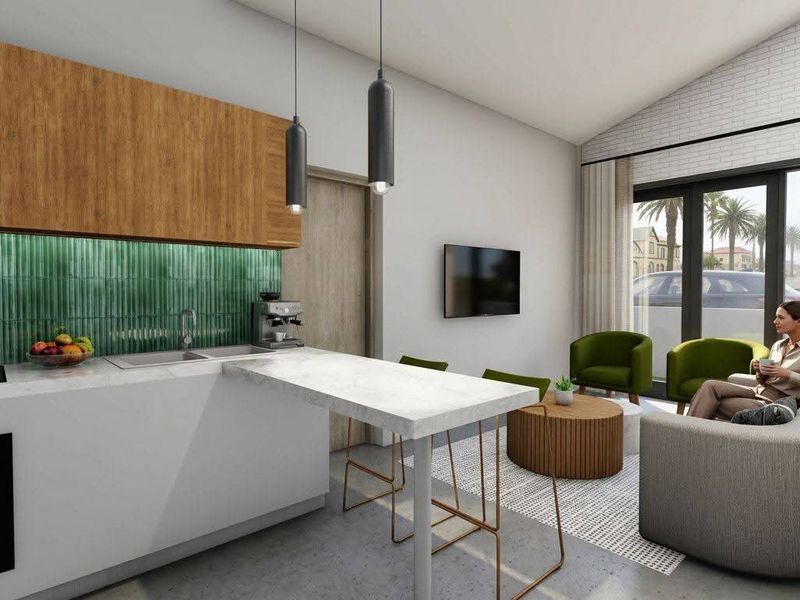 Modern open-plan living area featuring a sleek kitchen with wood-toned cabinetry, green tiled backsplash, and seamless flow to the lounge with large glass doors.