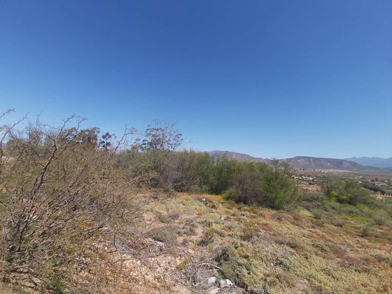 A scenic view overlooking the natural landscape and distant mountains from the vacant residential property.