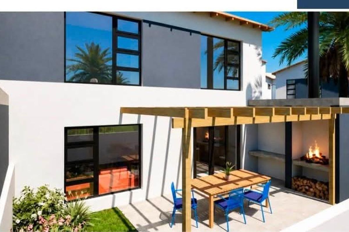 Rear exterior view of a modern townhouse featuring a paved patio, timber pergola, and a built-in braai area.