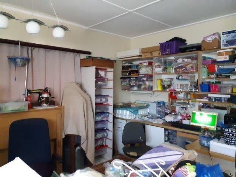 A functional home office space featuring built-in desk and shelving units, providing ample storage and workspace potential.