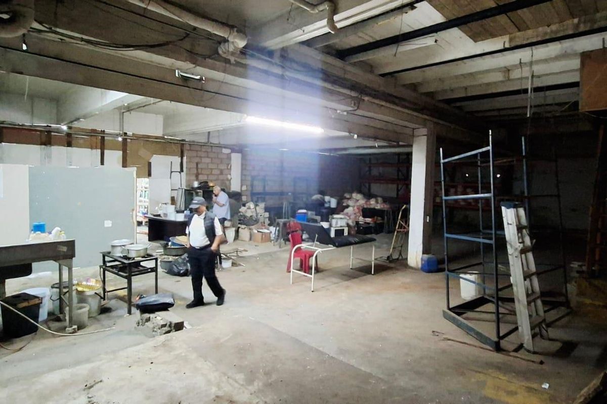 An expansive, unfinished industrial utility space featuring exposed concrete ceilings, structural steel columns, and raw concrete flooring, suitable for various commercial or industrial applications.