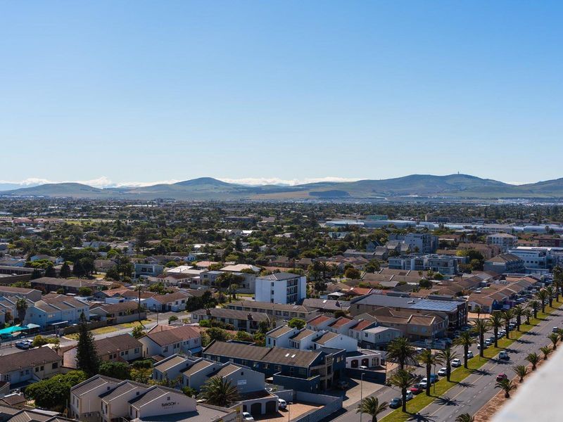 An elevated, panoramic view overlooking the surrounding residential neighborhood, suburban streets, and distant mountain range.
