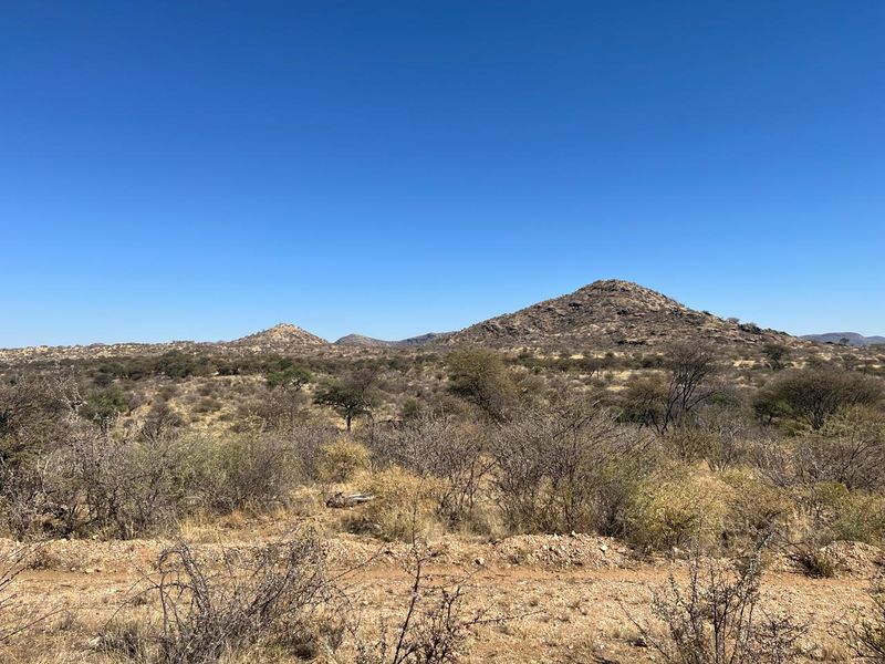 A scenic view of the natural landscape featuring rolling hills and arid vegetation on this vacant residential land.