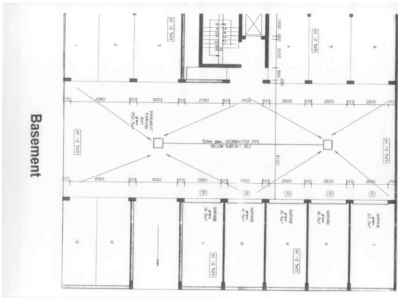 Architectural floor plan showing the basement layout, including multiple parking bays and individual garage units.