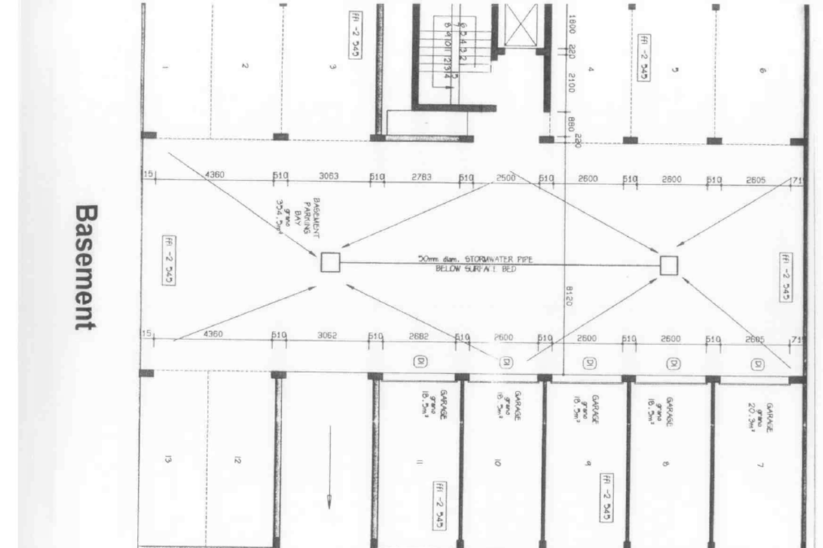 Architectural floor plan showing the basement layout, including multiple parking bays and individual garage units.