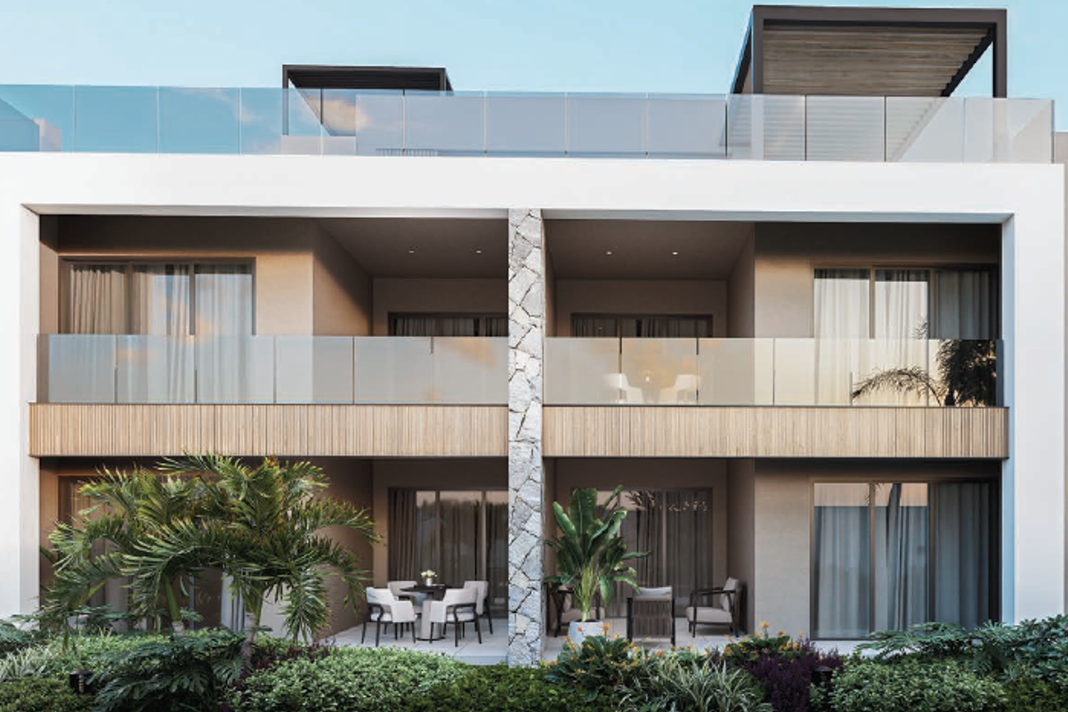 Modern apartment exterior featuring a multi-level facade with glass balustrades, stone accents, timber-look cladding, and private ground-floor patio areas.