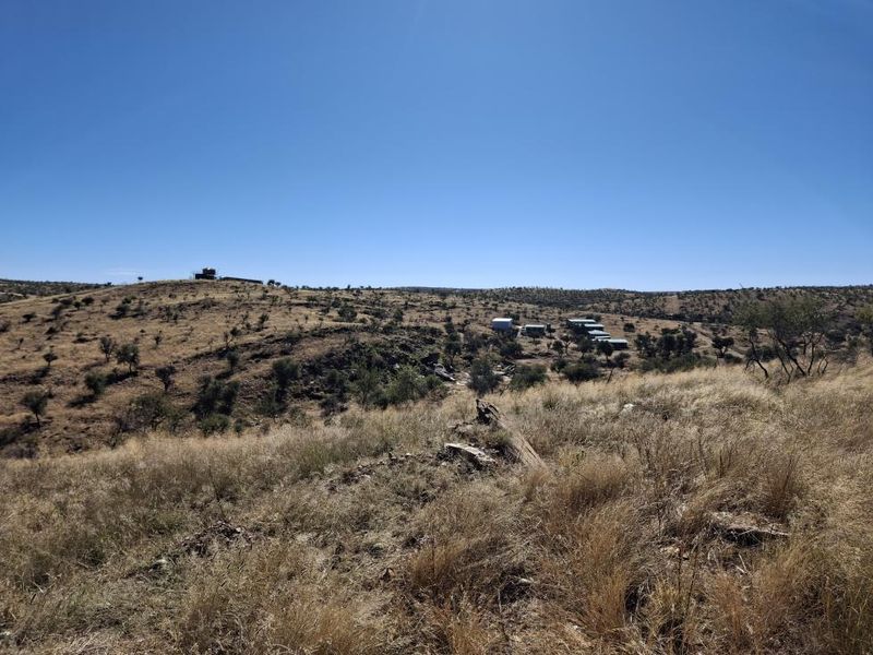 A wide-angle view of the expansive natural landscape and terrain characteristic of the small holding property.