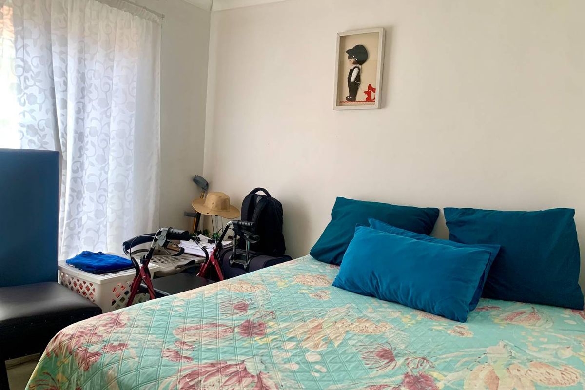 A standard bedroom featuring neutral walls and coving, providing a functional space for rest.