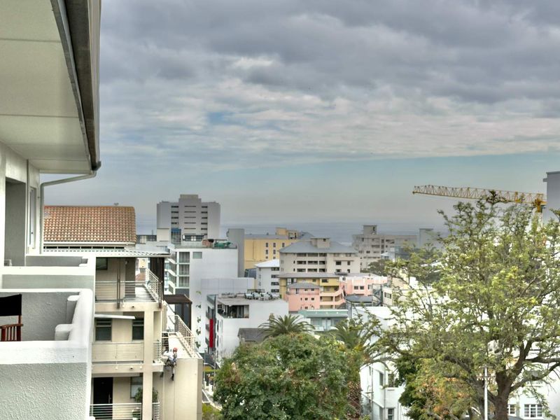 An elevated urban view overlooking the surrounding cityscape and neighborhood from a private balcony.
