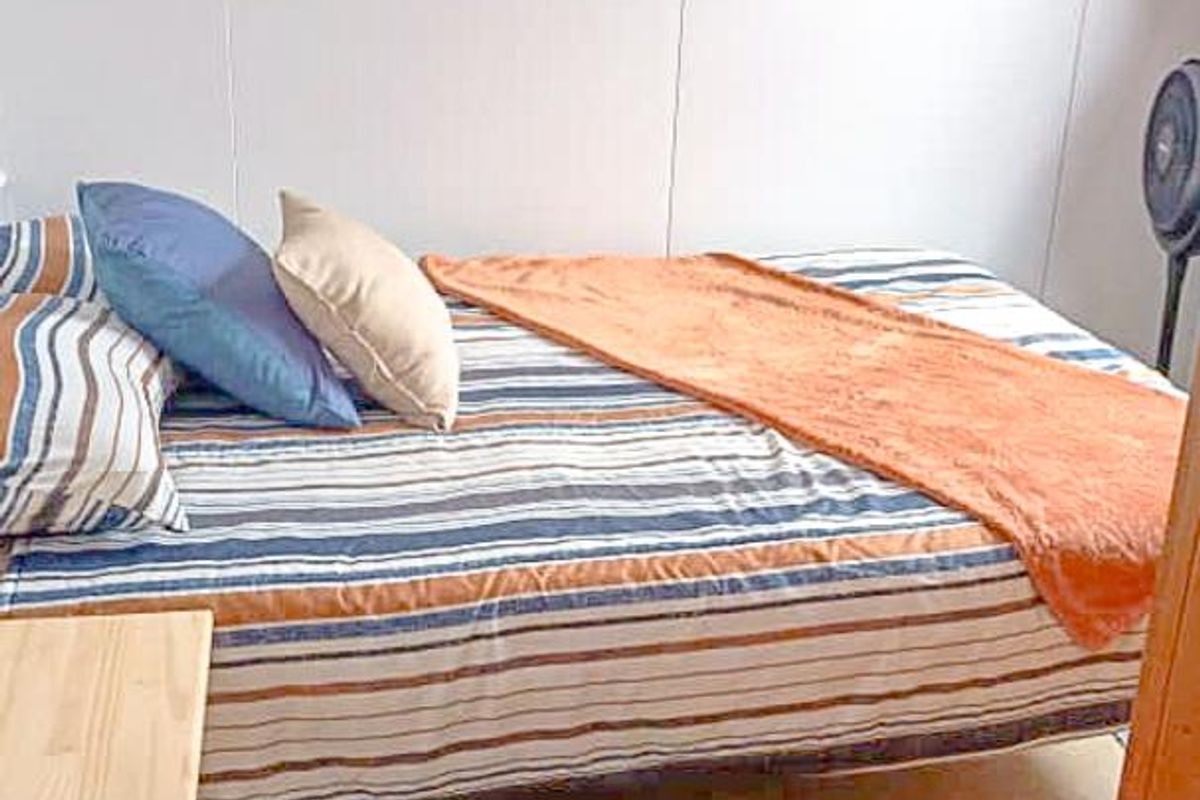 A compact bedroom featuring neutral wall finishes and simple flooring.