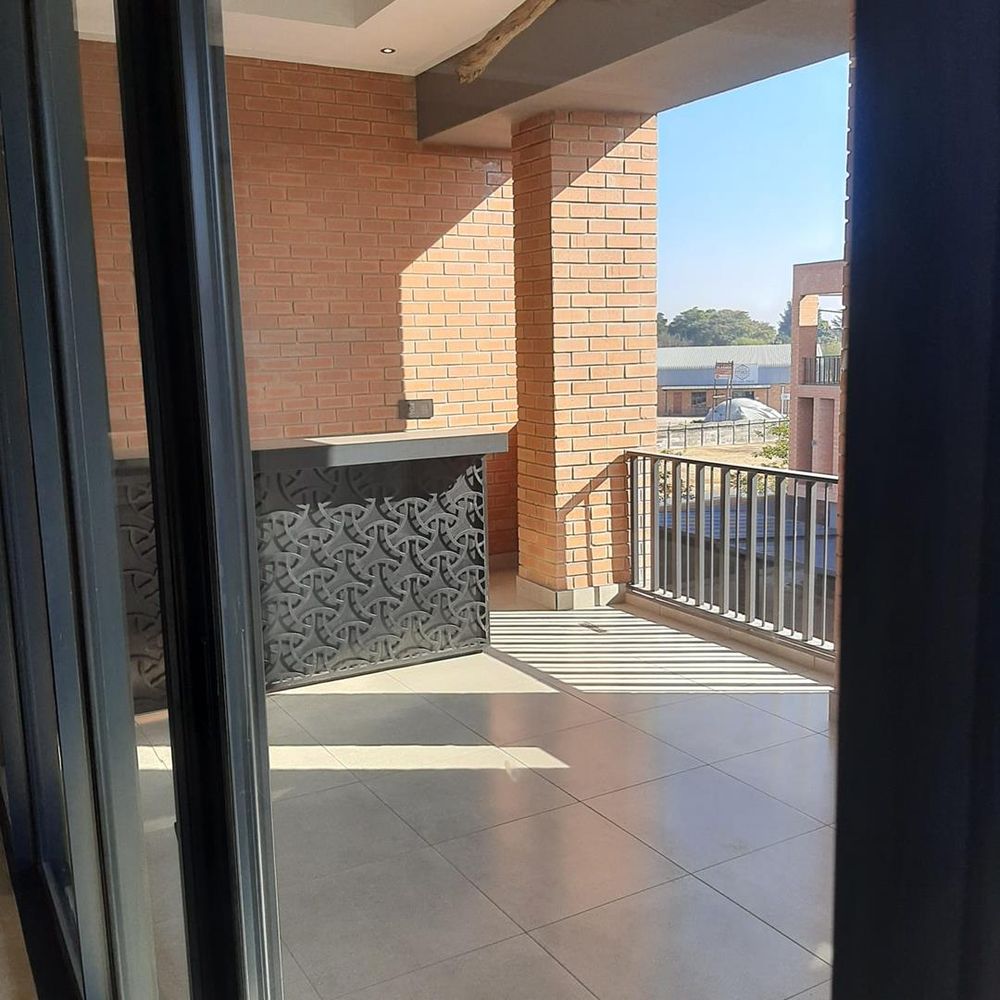 Large covered patio with built in braai and bar area