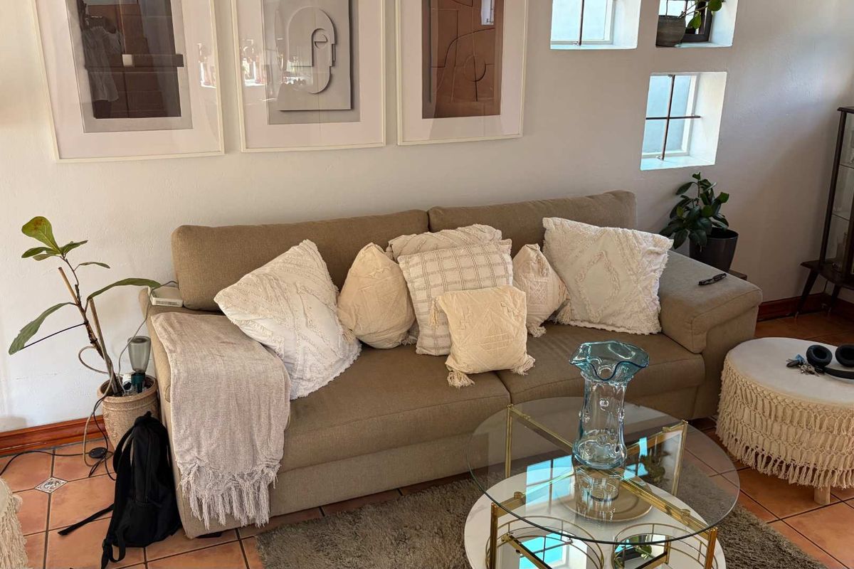 A cozy living room area featuring terracotta floor tiles and unique recessed windows, providing a warm and inviting atmosphere.