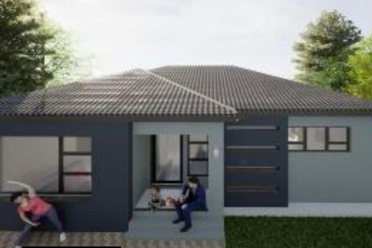 A modern rear exterior view of the house featuring a tiled roof, dark grey facade, and a covered patio entrance.