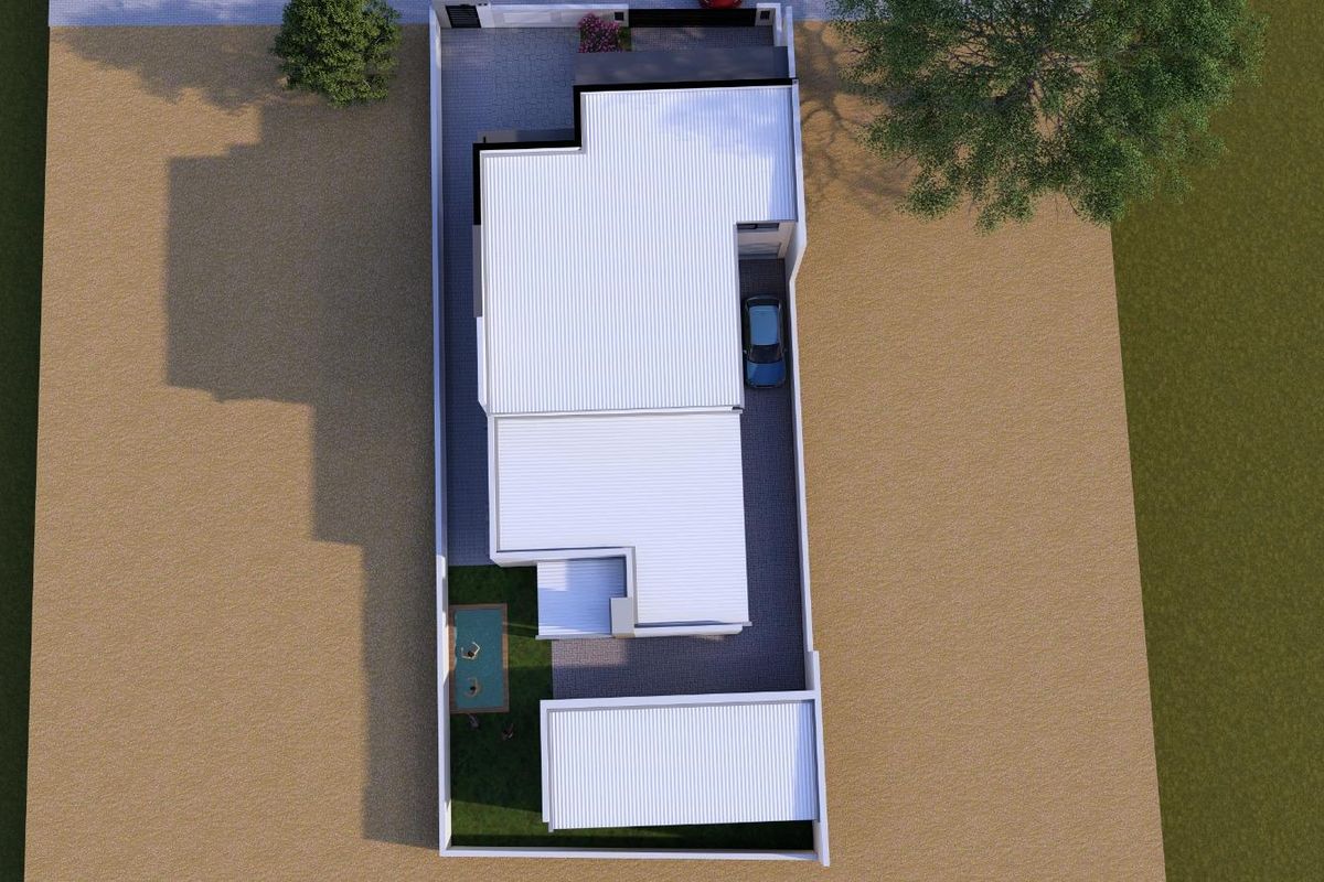 An aerial view of the property showing the roof layout, swimming pool, paved driveway, and surrounding boundary walls.