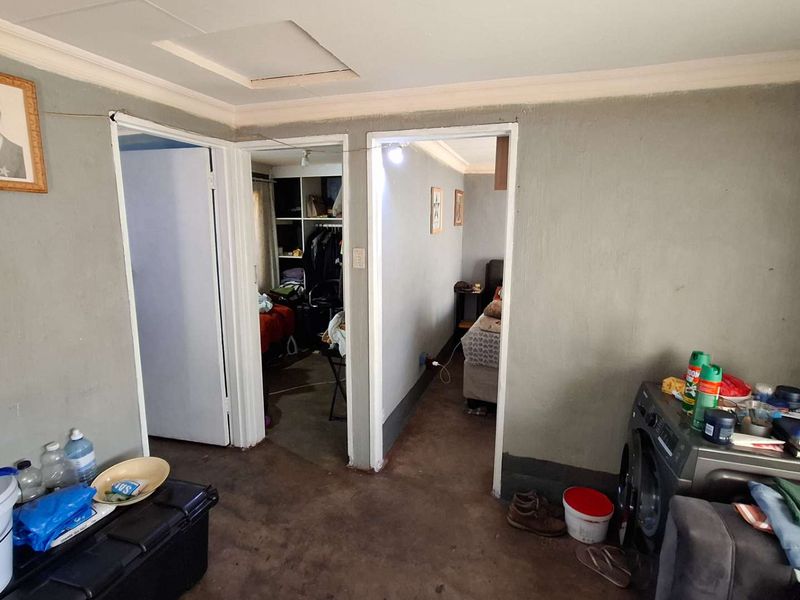 A functional hallway area providing access to adjacent rooms, featuring basic finishes and standard door frames.