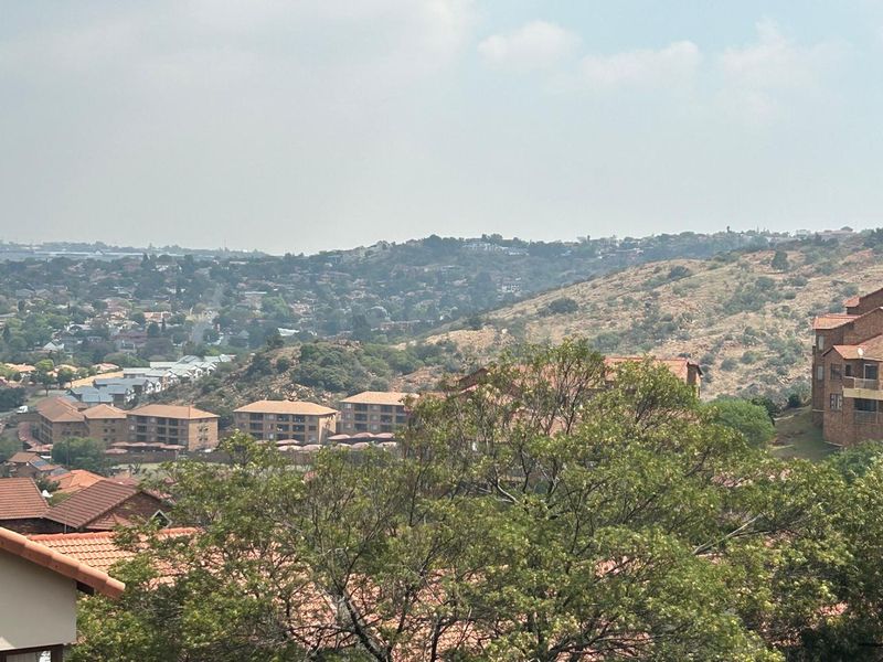 An elevated view overlooking the surrounding residential estate and hilly landscape.