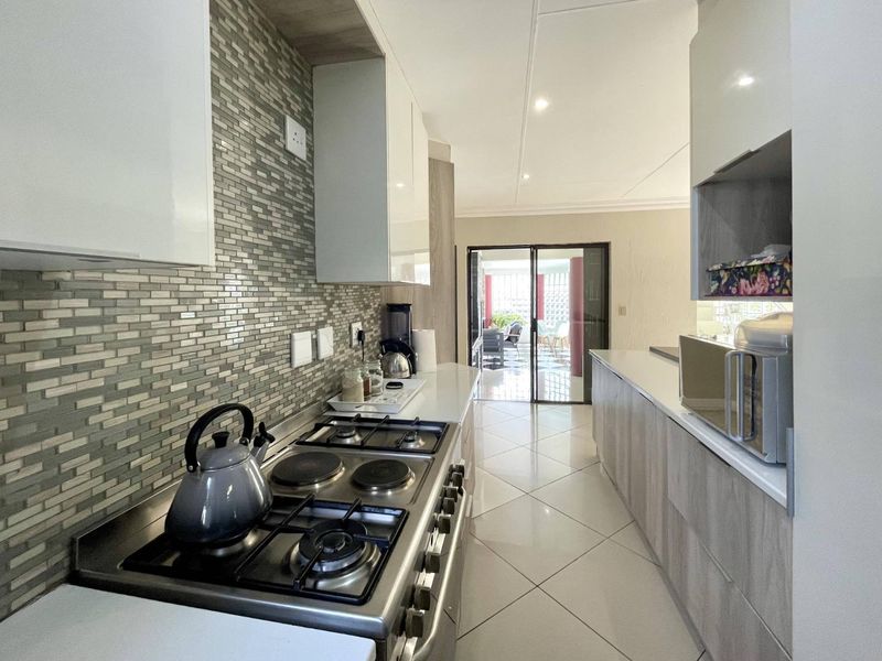 Spacious 4-Bedroom Family Home with Pool, Entertainment Areas & Solar Backup in Highveld - Photo 8