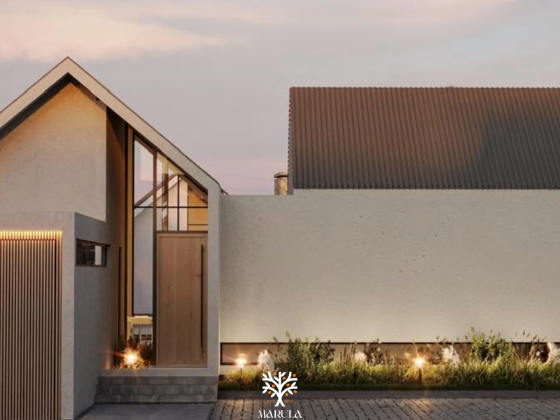 Modern townhouse facade featuring a pitched roof, timber entrance door, vertical cladding, and integrated exterior lighting with a paved driveway.