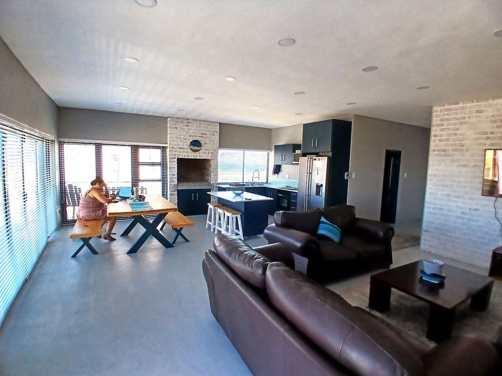 A generously-sized open Plan Living Area & Kitchen. Fire place at the back.