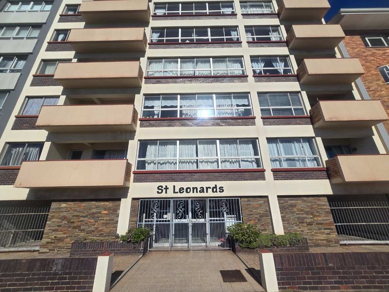 Front elevation of St Leonards apartment building featuring a brick facade, multiple balconies, and a secure gated entrance.