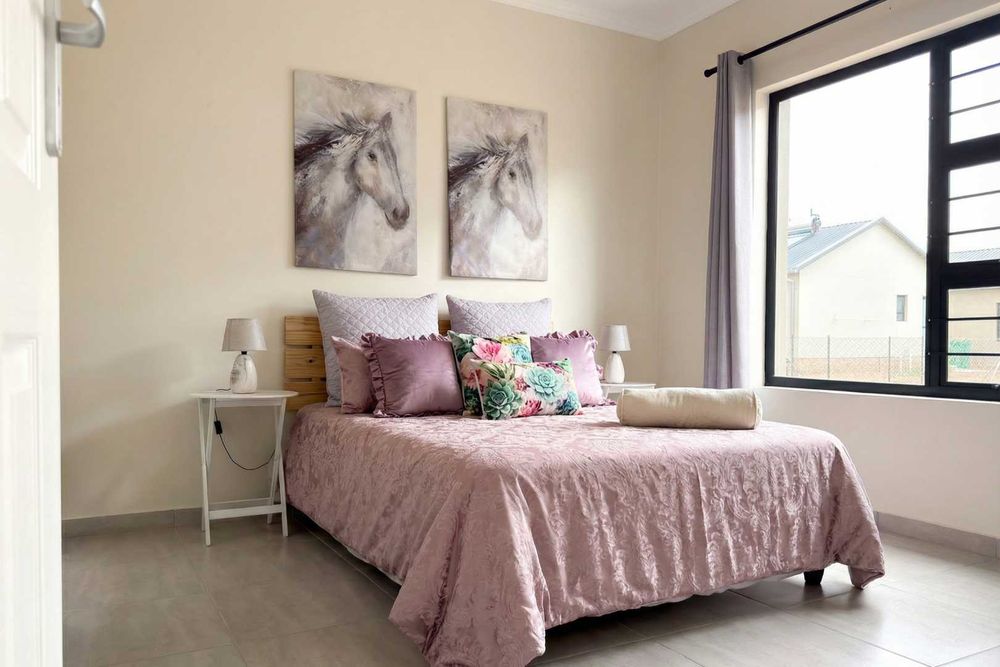 Main bedroom with built-in cupboards and ensuite bathroom.