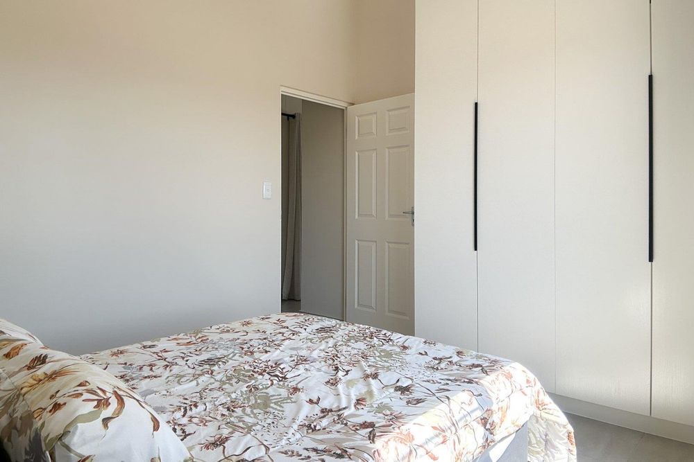 Spacious second bedroom with built-in cupboards.