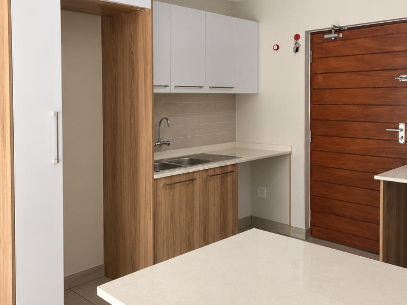 Modern kitchen featuring light wood and white cabinetry, stone countertops, stainless steel sink, and tiled flooring, presenting a clean and functional space.