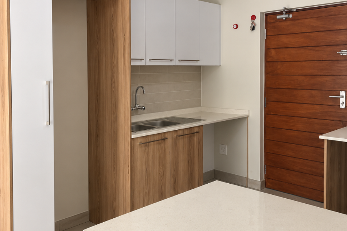 Modern kitchen featuring light wood and white cabinetry, stone countertops, stainless steel sink, and tiled flooring, presenting a clean and functional space.
