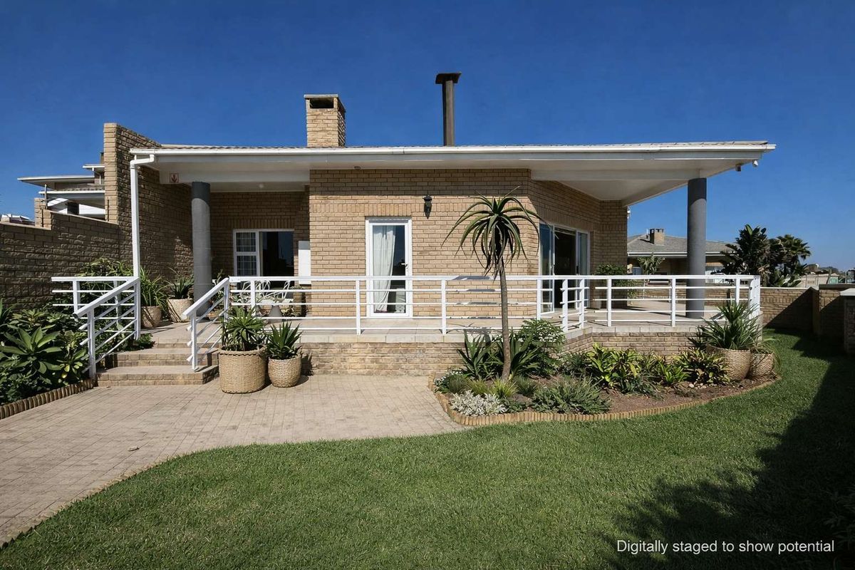 A well-maintained townhouse featuring a spacious covered patio, brick facade, and a landscaped garden area.