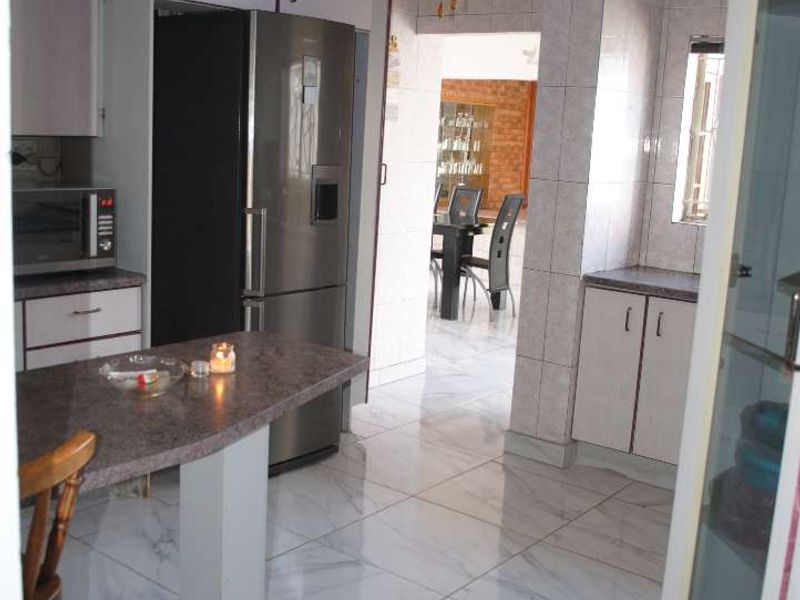 Renovated, built up, and expanded into a neat four-bedroom home with multiple living rooms and Bar area - Photo 9