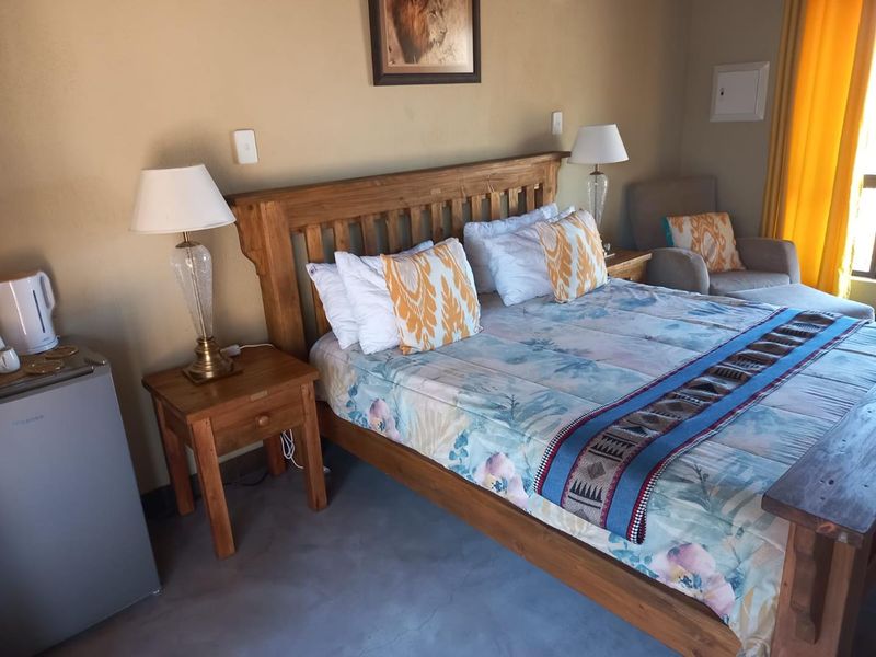 A bedroom featuring polished concrete flooring and neutral wall finishes, providing a functional and comfortable sleeping space.