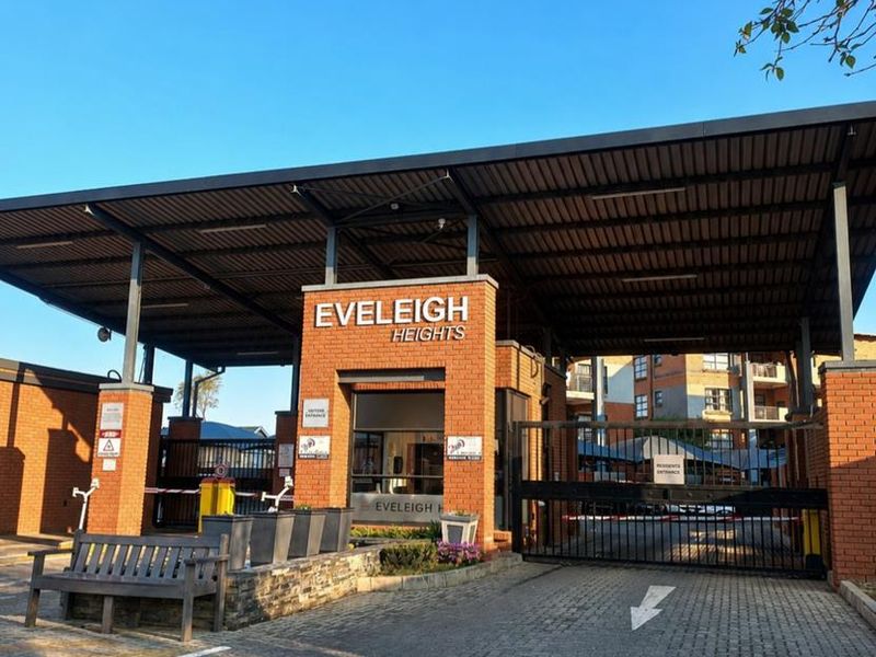 The main entrance gate and security checkpoint for Eveleigh Heights apartment complex, featuring brick construction and a covered access point.