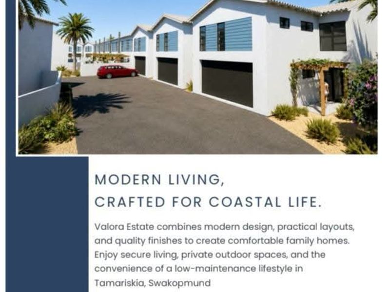 Modern residential estate facade featuring double garages, paved driveway, and clean architectural lines in a coastal setting.