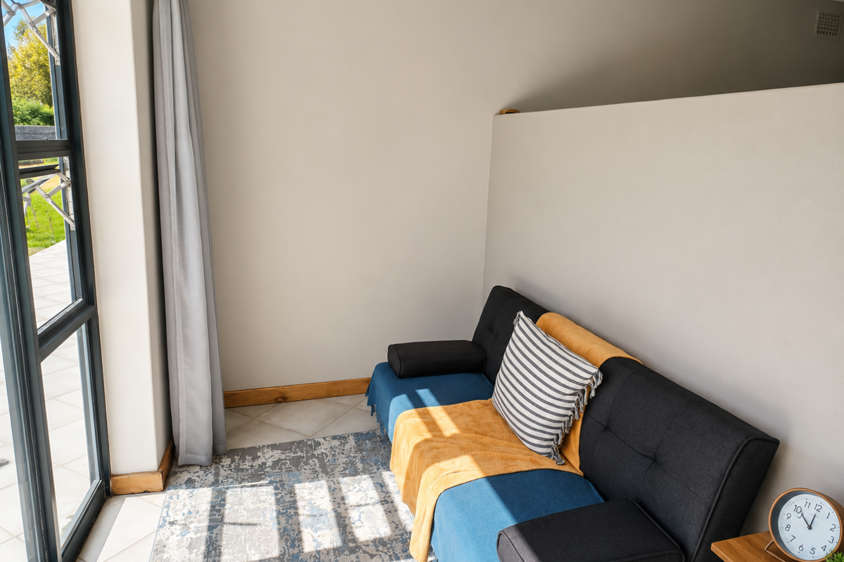 A bright living area featuring large glass sliding doors that provide natural light and access to the outdoor space.