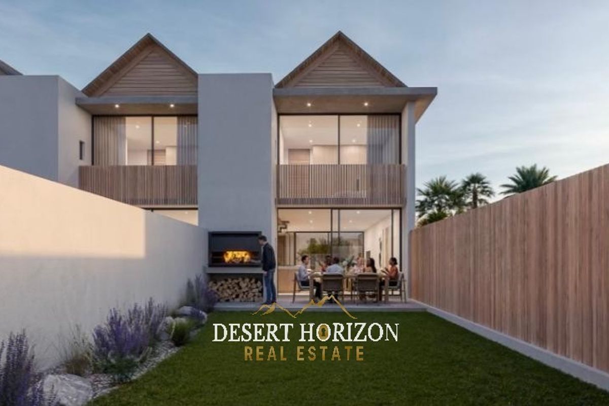 Rear view of a modern townhouse featuring a private garden, built-in braai area, and upper-level balconies with timber screening.